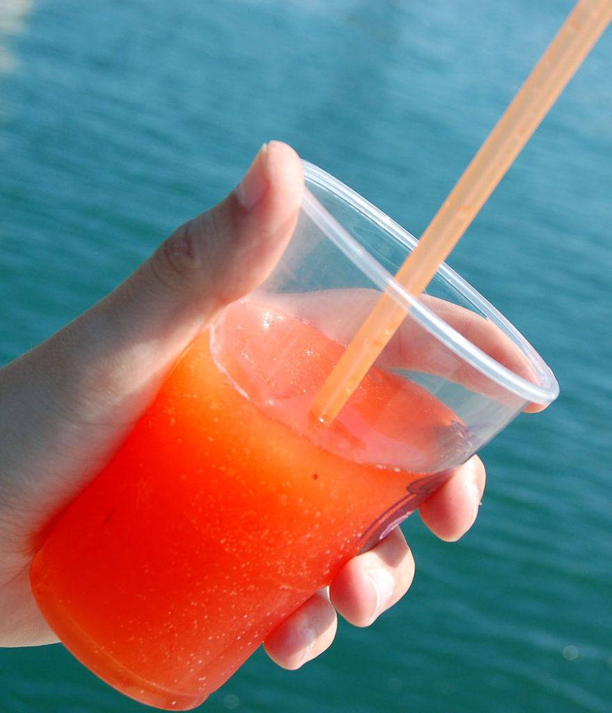 Hand-holding-a-glass-of-frozen-red-juice